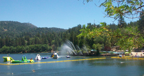 A group of people riding water skis on top of a lake.